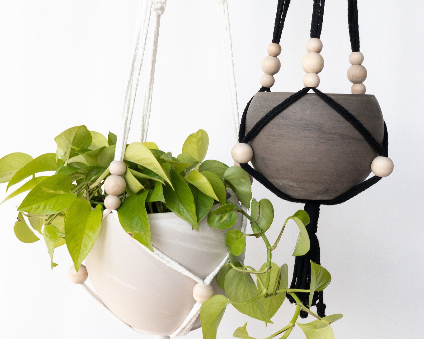 Close up of two boho style plant hangers with beads