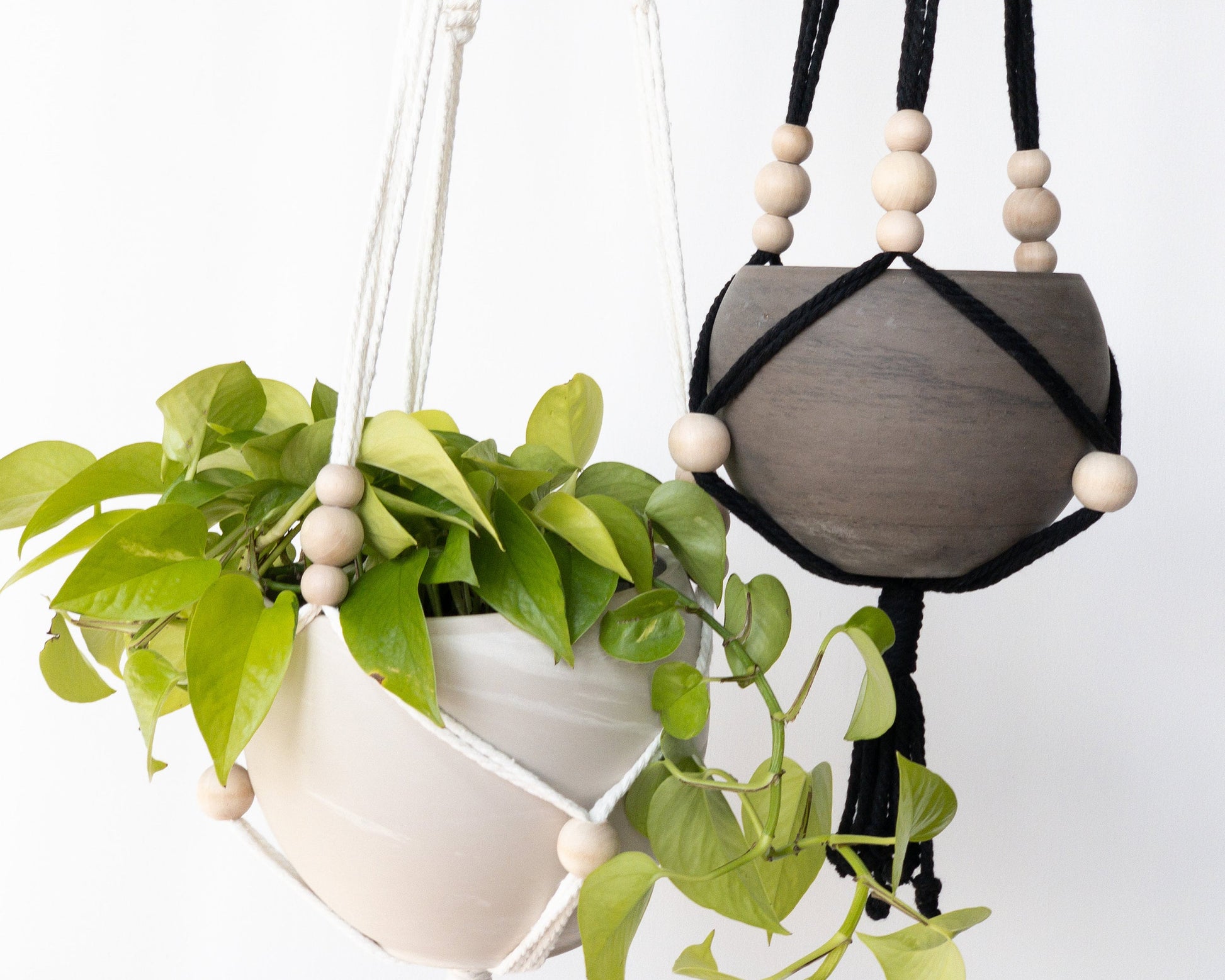 Close up of two boho style plant hangers with beads