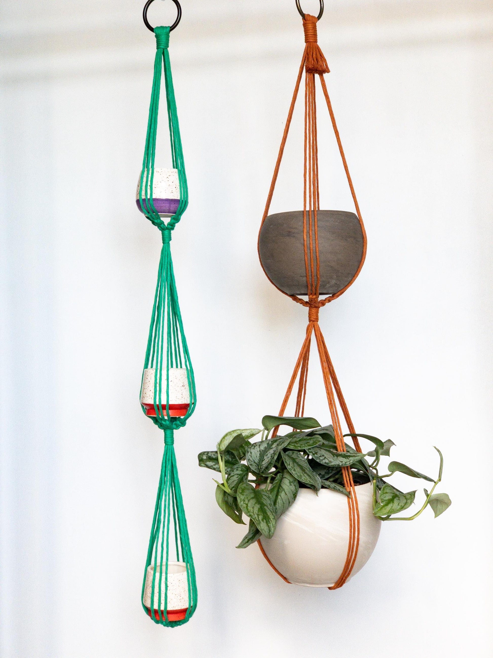 Two plant hangers.  One holds 3 pots the other holds 2 pots.  Shown in Kelly Green and Copper
